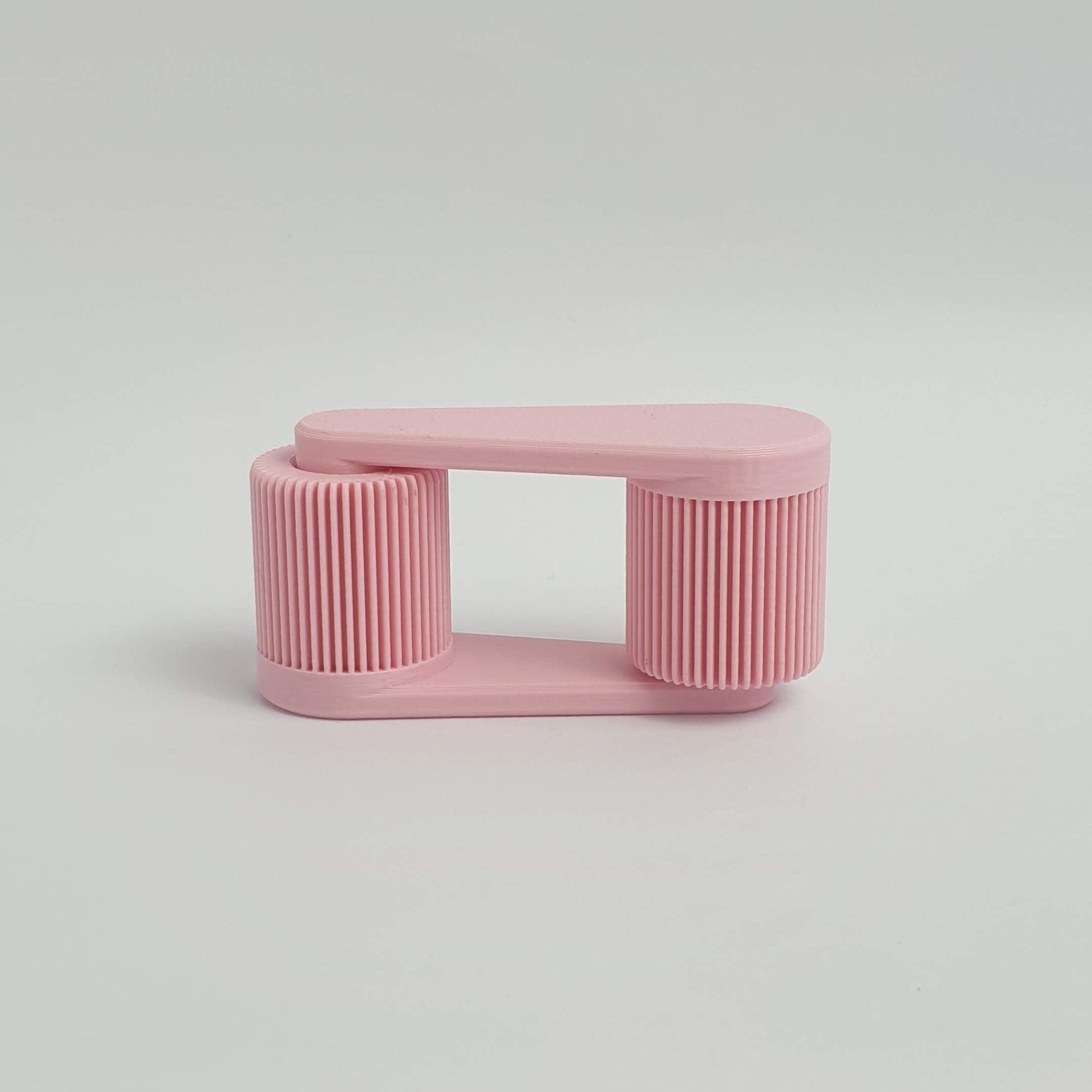 3d printed pink mini portable laptop stand on a light gray background by Mina 3D Prints