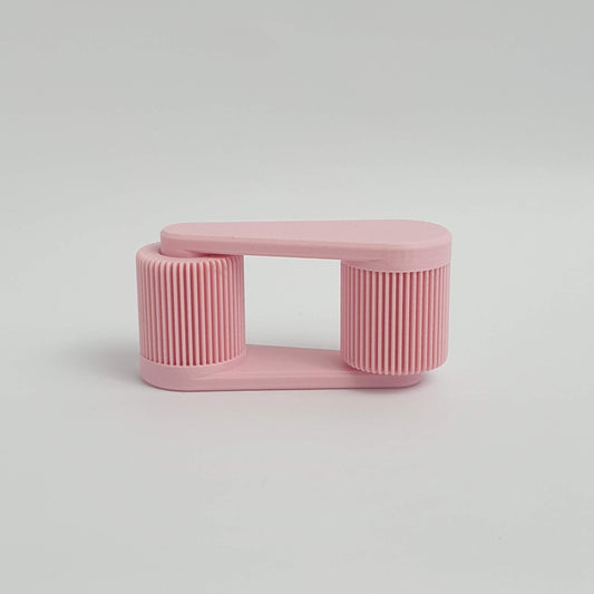 3d printed pink mini portable laptop stand on a light gray background by Mina 3D Prints